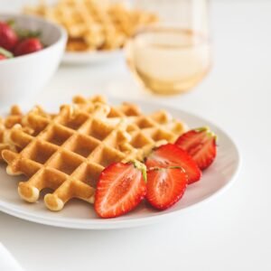 Belgian waffles with strawberry on white plate. Breakfast food concept. Copy space