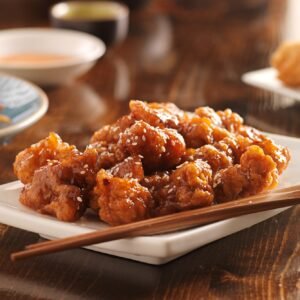 chinese sesame chicken with chopsticks