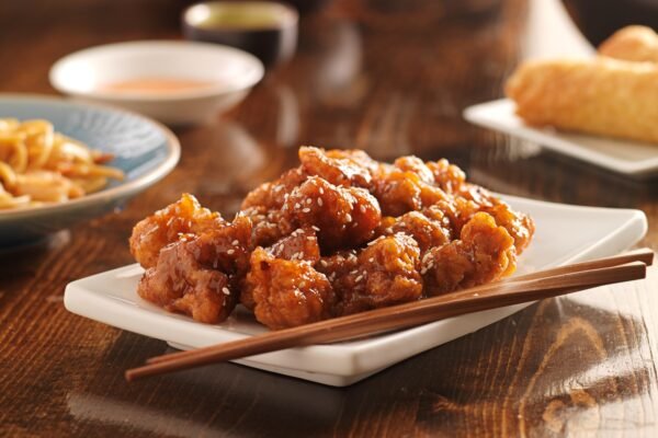 chinese sesame chicken with chopsticks