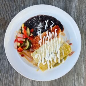 Overhead view of enchiladas, beans and vegetables